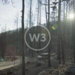 Slow Motion Dolly Shot Of Forest Burnt By The White Rock Lake Fire At Sunset With SUV And Boat Trailer