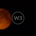 A Blood Orange Moon Traverses The Night Sky With Pine Trees In the Foreground In Timelapse